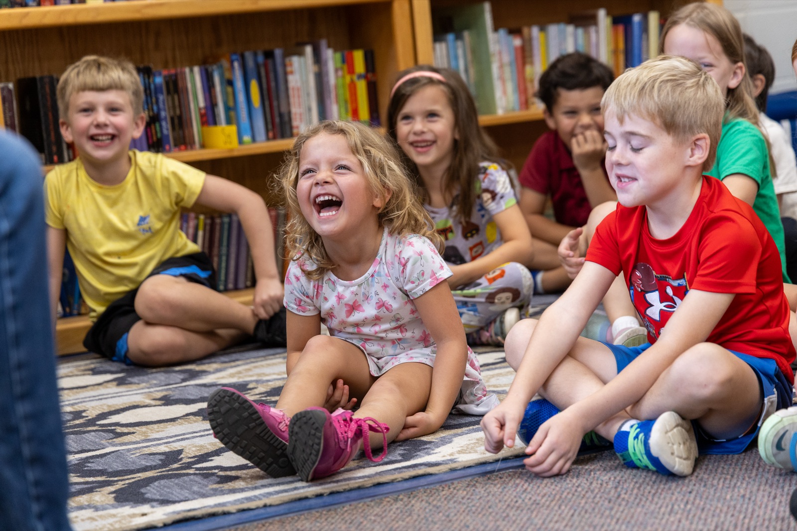 Lower Schoolers laughing during a library read-aloud