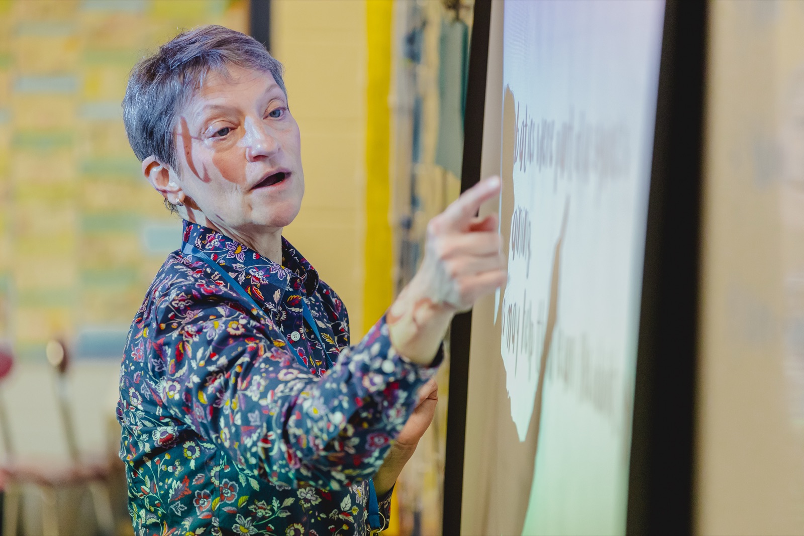 Teacher pointing at projected text